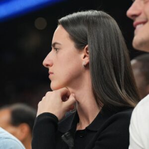Indiana Fever player Caitlin Clark attends the game between the Phoenix Suns and the Golden State Warriors during the first half at Footprint Center.