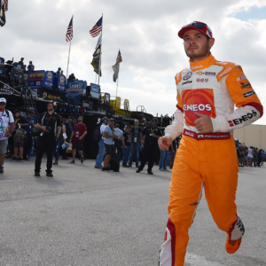 NASCAR Sprint Cup Series driver Kyle Larson (42) runs through the garage area during practice for the Ford Ecoboost 400 at Homestead-Miami Speedway.
