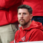 Denny Hamlin looks on before the CFP National Championship college football game at Mercedes-Benz Stadium.