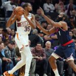 LA Clippers guard James Harden (1) guards Phoenix Suns forward Kevin Durant (35) during the second half at Footprint Center.