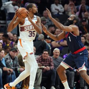 LA Clippers guard James Harden (1) guards Phoenix Suns forward Kevin Durant (35) during the second half at Footprint Center.
