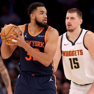 New York Knicks center Karl-Anthony Towns (32) controls the ball against Denver Nuggets center Nikola Jokic (15) during the third quarter at Madison Square Garden