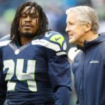Seattle Seahawks head coach Pete Carroll talks with Seattle Seahawks running back Marshawn Lynch (24) during pre game warmups against the Arizona Cardinals at CenturyLink Field.