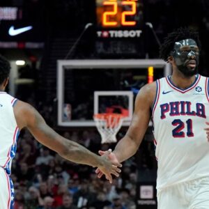 Philadelphia 76ers center Joel Embiid (21) and forward Paul George (8) high five during the second half against the Portland Trail Blazers at Moda Center.