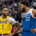Los Angeles Lakers guard D'Angelo Russell (1) and Minnesota Timberwolves center Karl-Anthony Towns (32) talk during a free throw in the first half at Target Center