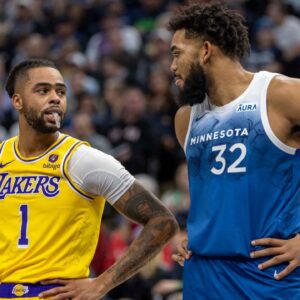 Los Angeles Lakers guard D'Angelo Russell (1) and Minnesota Timberwolves center Karl-Anthony Towns (32) talk during a free throw in the first half at Target Center