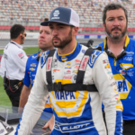 May 25, 2024; Concord, North Carolina, USA; NASCAR Cup Series driver Chase Elliott (9) walks with his car during qualifying at Charlotte Motor Speedway. Mandatory Credit: Jim Dedmon-Imagn Images