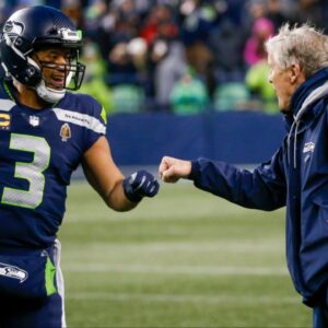 Seattle Seahawks quarterback Russell Wilson (3) bumps fists with head coach Pete Carroll during the fourth quarter two-minute warning against the Detroit Lions at Lumen Field.