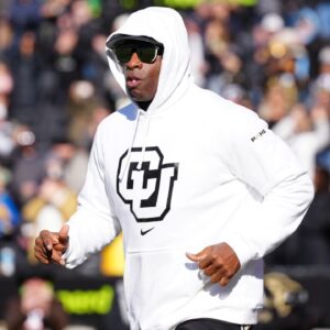 Colorado Buffaloes head coach Deion Sanders runs onto the field before the game against the Oklahoma State Cowboys at Folsom Field.