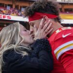 Kansas City Chiefs quarterback Patrick Mahomes (15) kisses his wife Brittany prior to a game against the Las Vegas Raiders at GEHA Field at Arrowhead Stadium.