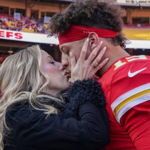 Kansas City Chiefs quarterback Patrick Mahomes (15) kisses his wife Brittany prior to a game against the Las Vegas Raiders at GEHA Field at Arrowhead Stadium.