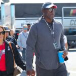 Michael Jordan and his wife Yvette Jordan walk through the garage area at Daytona International Speedway.