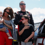 Jul 22, 2023; Long Pond, Pennsylvania, USA; NASCAR Craftsman Truck Series driver Kyle Busch stands with his wife Samantha Busch and children Brexton and Lennix prior to the CRC Brakleen 150 at Pocono Raceway. Mandatory Credit: Matthew O'Haren-Imagn Images