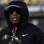 Colorado Buffaloes head coach Deion Sanders runs on the field before the game against the Kansas State Wildcats at Folsom Field.
