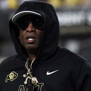 Colorado Buffaloes head coach Deion Sanders runs on the field before the game against the Kansas State Wildcats at Folsom Field.