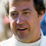 Driver Harry Gant takes a break during qualifying trials for the Nashville Pepsi 420 NASCAR Grand National race at Nashville International Raceway on July 13, 1984.