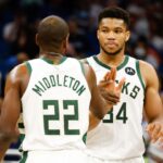 Milwaukee Bucks forward Khris Middleton (22) and forward Giannis Antetokounmpo (34) celebrate a three point shot in the second half against the Orlando Magic at Amway Center.