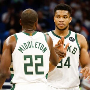 Milwaukee Bucks forward Khris Middleton (22) and forward Giannis Antetokounmpo (34) celebrate a three point shot in the second half against the Orlando Magic at Amway Center.
