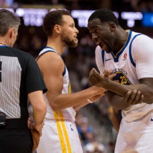 Golden State Warriors guard Stephen Curry (30) and forward Draymond Green (23) and referee Scott Foster (48) during the game against the Dallas Mavericks at the American Airlines Center. The Warriors defeat the Mavericks 125-122.
