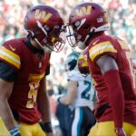 Washington Commanders quarterback Jayden Daniels (5) celebrates with Commanders wide receiver Terry McLaurin (17) after connecting on a touchdown pass against the Philadelphia Eagles during the second quarter at Northwest Stadium