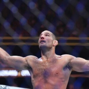 Sean Strickland (red gloves)celebrates defeating Paulo Costa (blue gloves) during UFC 302 at Prudential Center.