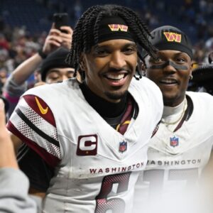 Jan 18, 2025; Detroit, Michigan, USA; Washington Commanders quarterback Jayden Daniels (5) and wide receiver Terry McLaurin (17) celebrate the win against Detroit Lions in a 2025 NFC divisional round game at Ford Field.