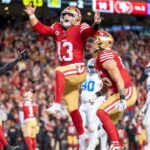 California, USA; San Francisco 49ers quarterback Brock Purdy (13) celebrates with tight end George Kittle (85) after scoring a touchdown against the Detroit Lions during the second quarter at Levi's Stadium.