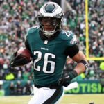 Jan 26, 2025; Philadelphia, PA, USA; Philadelphia Eagles running back Saquon Barkley (26) runs with the ball for a touchdown against the Washington Commanders during the first half in the NFC Championship game at Lincoln Financial Field.