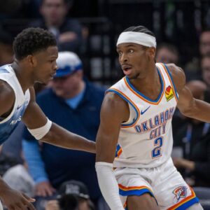Oklahoma City Thunder guard Shai Gilgeous-Alexander (2) looks to pass the ball as Minnesota Timberwolves guard Anthony Edwards (5) plays defense in the second half at Target Center.