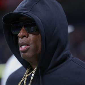 Colorado Buffaloes head coach Deion Sanders jogs on the field before the game against the Brigham Young Cougars at Alamodome.