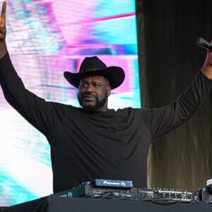Shaquille O'Neal holds up the sign of the horns during a DJ performance ahead of the College Football Playoff semifinal game between the Texas Longhorns and Ohio State in the Cotton Bowl at AT&T Stadium