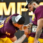 Arizona State Sun Devils quarterback Sam Leavitt (10) signs the WWE Big 12 championship belt of running back Cam Skattebo (4) celebrates after the Sun Devils defeat the Iowa State Cyclones and win the 2024 Big 12 Championship at AT&T Stadium.
