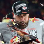 Jan 26, 2025; Kansas City, MO, USA; Kansas City Chiefs tight end Travis Kelce (87) reacts on stage after the AFC Championship game against the Buffalo Bills at GEHA Field at Arrowhead Stadium.