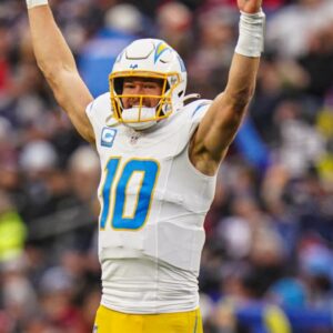 Dec 28, 2024; Foxborough, Massachusetts, USA; Los Angeles Chargers quarterback Justin Herbert (10) reacts after his touchdown pass against the New England Patriots in the third quarter at Gillette Stadium.