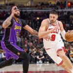 Chicago Bulls center Nikola Vucevic (9) drives to the basket against Los Angeles Lakers forward Anthony Davis (3) during the first half at United Center.