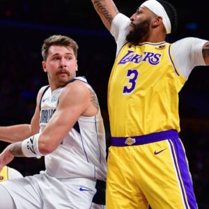 Dallas Mavericks guard Luka Doncic (77) passes the ball against Los Angeles Lakers forward Anthony Davis (3) during the first half at Crypto.com Arena.