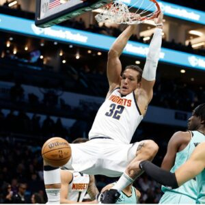 Feb 1, 2025; Charlotte, North Carolina, USA; Denver Nuggets forward Aaron Gordon (32) follows through on a slam dunk during the first quarter against the Charlotte Hornets at Spectrum Center. Mandatory Credit: Brian Westerholt-Imagn Images
