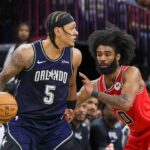 Orlando Magic forward Paolo Banchero (5) moves the ball around Chicago Bulls guard Coby White (0) during the second half at KIA Center.