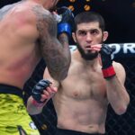 Islam Makhachev (red gloves) fights Renato Moicano (blue gloves) in a lightweight title fight during UFC 311 at Intuit Dome.