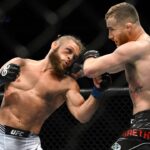 Justin Gaethje (red gloves) fights Rafael Fiziev (blue gloves) during UFC 286 at O2 Arena.