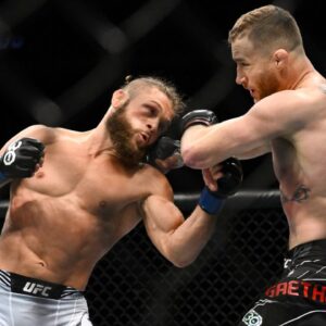 Justin Gaethje (red gloves) fights Rafael Fiziev (blue gloves) during UFC 286 at O2 Arena.