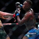 Alex Pereira (red gloves) fights Israel Adesanya (blue gloves) during UFC 287 at Miami-Dade Arena.