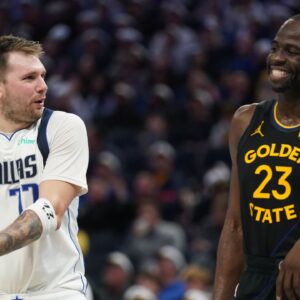Dallas Mavericks guard Luka Doncic (77) talks with Golden State Warriors forward Draymond Green (23) after being called for a foul in the fourth quarter at the Chase Center