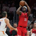 Miami Heat forward Jimmy Butler (22) shoots the ball against Phoenix Suns guard Grayson Allen (8) during the second half at Kaseya Center.