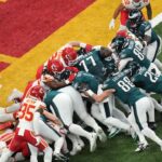 Philadelphia Eagles quarterback Jalen Hurts (1) rushes the ball for a touchdown against the Kansas City Chiefs during the first quarter in Super Bowl LIX at Caesars Superdome.