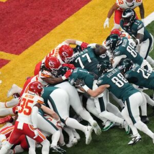 Philadelphia Eagles quarterback Jalen Hurts (1) rushes the ball for a touchdown against the Kansas City Chiefs during the first quarter in Super Bowl LIX at Caesars Superdome.