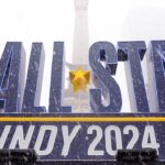 Snow falls Friday, Feb. 16, 2024, in front of an NBA All-Star Indy 2024 sign on Monument Circle in Indianapolis.