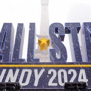 Snow falls Friday, Feb. 16, 2024, in front of an NBA All-Star Indy 2024 sign on Monument Circle in Indianapolis.