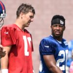 Aug 7, 2018; East Rutherford, NJ, USA; New York Giants quarterback Eli Manning (10) and rookie running back Saquon Barkley (26) talk on the field during training camp.