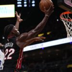 Miami Heat forward Jimmy Butler (22) shoots the ball around Golden State Warriors forward Andrew Wiggins (22) during the second half at FTX Arena.